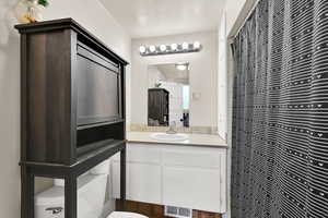 Bathroom featuring vanity and toilet