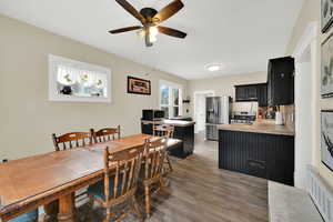 Dining space with light wood finished floors and a ceiling fan