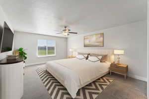 Carpeted bedroom featuring a textured ceiling and a ceiling fan
