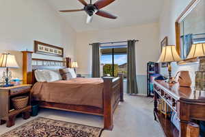 Bedroom featuring light carpet, a ceiling fan, and a textured wall