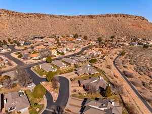 Aerial overview of property's location with nearby suburban area and a mountain backdrop