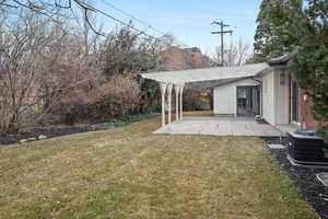 View of green lawn featuring a patio and a pergola