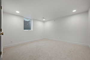 Unfurnished room featuring light colored carpet and recessed lighting