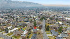 Aerial overview of property's location with a mountain backdrop and nearby suburban area