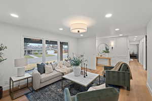 Living area featuring light wood finished floors and recessed lighting