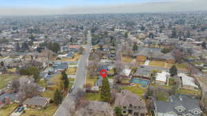 Aerial view of property and surrounding area with nearby suburban area