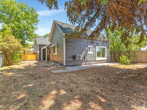 Rear view of property with a fenced backyard and a shingled roof