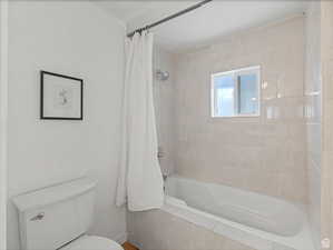 Full bathroom with tiled shower / bath and toilet
