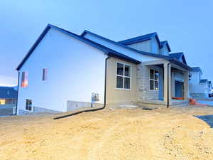 View of home's exterior featuring a porch and stone siding