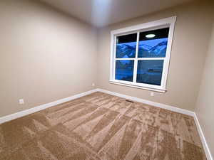 Unfurnished room with carpet floors and baseboards