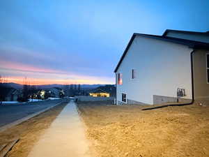 View of side of home with stucco siding and a residential view