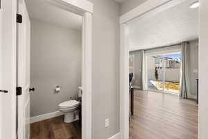 Bathroom featuring dark wood-style flooring and baseboards
