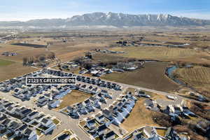Aerial view of property's location with rural landscape, farmland, and a mountainous background