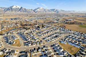 Aerial view of property's location with nearby suburban area and a mountain backdrop