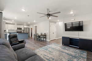 Living area featuring wood finished floors, recessed lighting, and ceiling fan