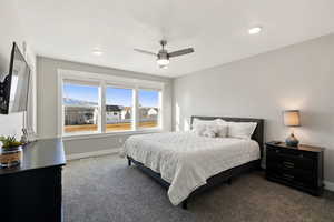 Primary bedroom featuring carpet flooring, a ceiling fan, and recessed lighting