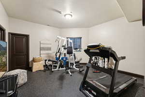 Workout area featuring rubber floors and baseboards