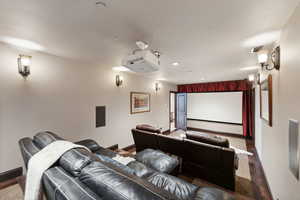 Home theater featuring baseboards and recessed lighting