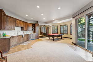 Rec room with pool table, light carpet, recessed lighting, light tile patterned floors, and arched walkways