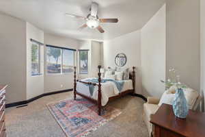 Bedroom with light colored carpet and a ceiling fan