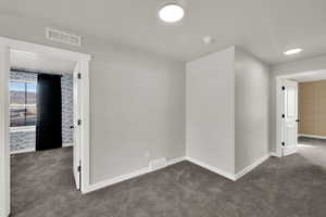 Spare room featuring carpet