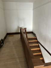 Stairway with wood-type flooring and baseboards