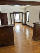 Unfurnished living room with french doors, light wood finished floors, and plenty of natural light