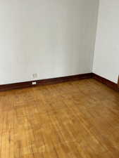 Unfurnished room featuring wood-type flooring