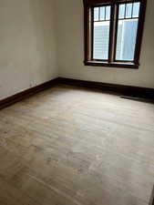 Empty room with baseboards and light wood-style floors
