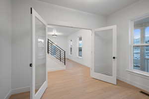 Hall featuring light wood-style floors and stairway