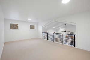 Empty room with recessed lighting, light carpet, ceiling fan, and lofted ceiling