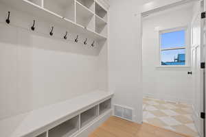 Mudroom with baseboards and light flooring