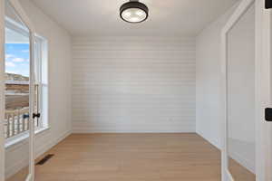 Empty room featuring light wood-type flooring and baseboards
