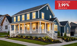 Two-story residence featuring a classic front porch with white railings and columns, blue siding, a dark shingled roof, and multiple windows