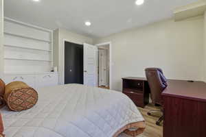 Bedroom featuring a desk, light wood-style floors, and recessed lighting