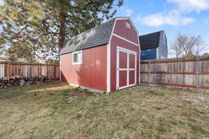 View of shed with a fenced backyard