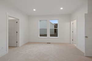 Unfurnished room featuring light carpet and recessed lighting