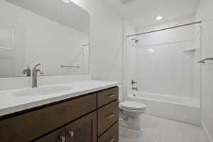 Full bath with vanity, shower / bathtub combination, and light tile patterned flooring