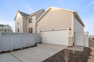 View of home's exterior with a gate and driveway