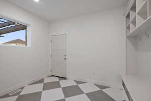 Mudroom with light flooring and baseboards