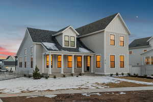 Modern inspired farmhouse featuring a porch, a shingled roof, and board and batten siding