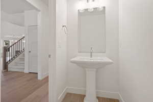 Bathroom with light wood-type flooring and baseboards