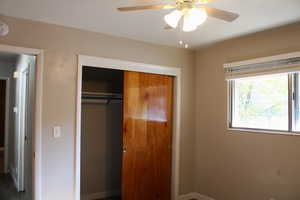 Unfurnished bedroom featuring a closet and ceiling fan
