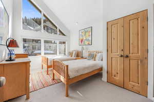 Bedroom with high vaulted ceiling and ensuite bath