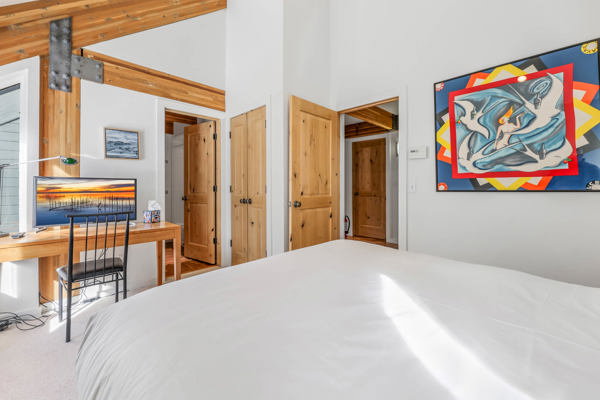 Carpeted bedroom,  closet with organizer, high vaulted ceiling and ensuite bathroom