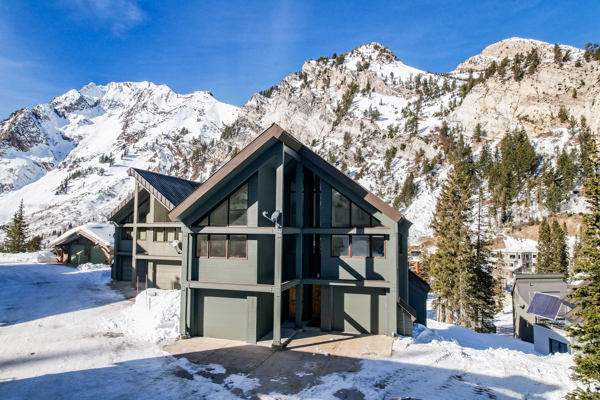 Front of home with a mountain view and a garage