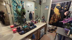 Full bathroom featuring double vanity and shower / tub combo