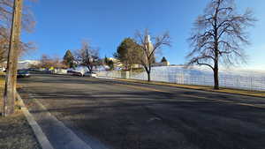 View of asphalt street featuring curbs