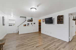 Finished below grade area featuring light wood-style floors and baseboards