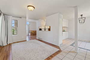 Empty room featuring baseboards and light tile patterned flooring